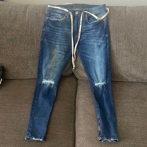 Blue washed YoungLA distressed jeans with zippered ankles. Size 32/30